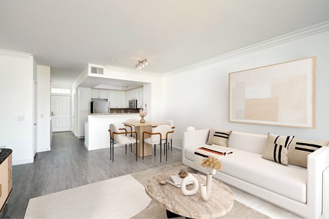A living room with a white couch and a coffee table.