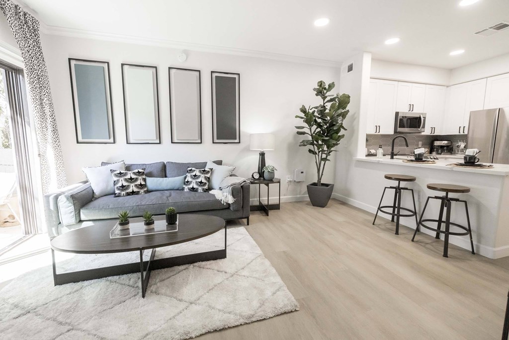 A modern living room with a grey sofa and a coffee table.