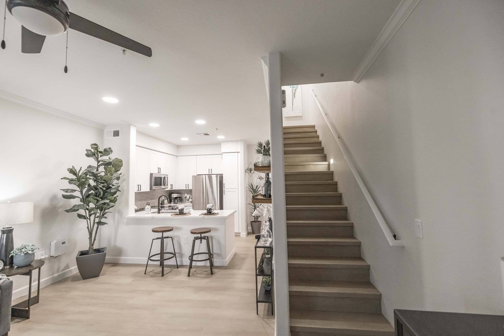 A living room with a staircase leading to the upper floor.