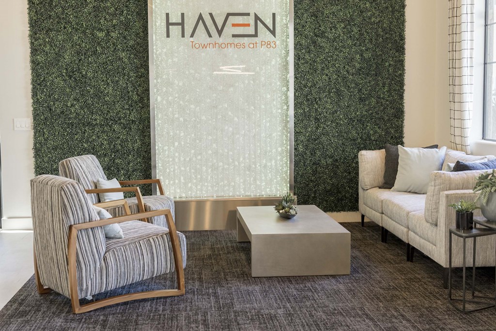 A room with a green wall and a sign that says "HAVEN Townhomes at P83".