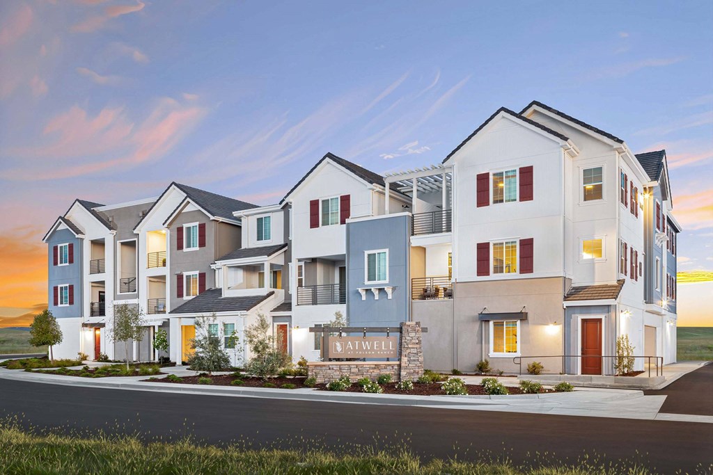 A row of modern townhouses with the name "Aftwell" on the front of the first one.