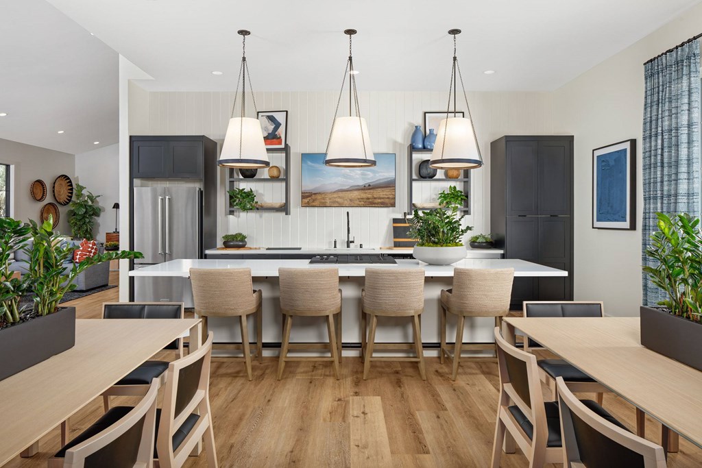 A modern kitchen with a dining table and chairs.