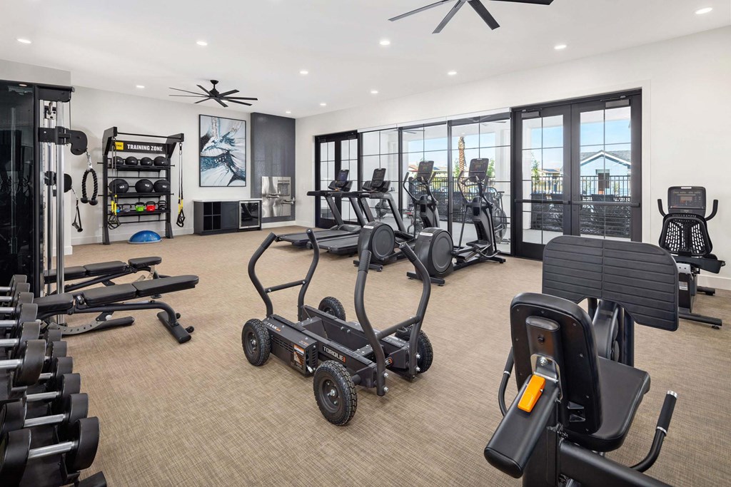 A spacious gym with a variety of equipment including treadmills, weights, and exercise machines.