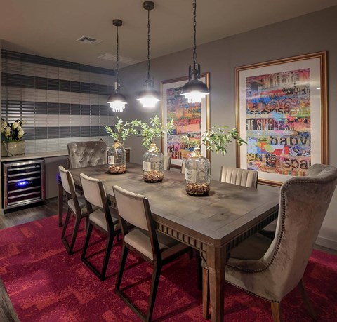 A dining room with a table and chairs.