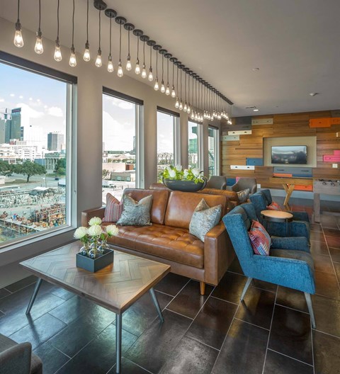 A living room with a brown leather couch and a wooden coffee table.