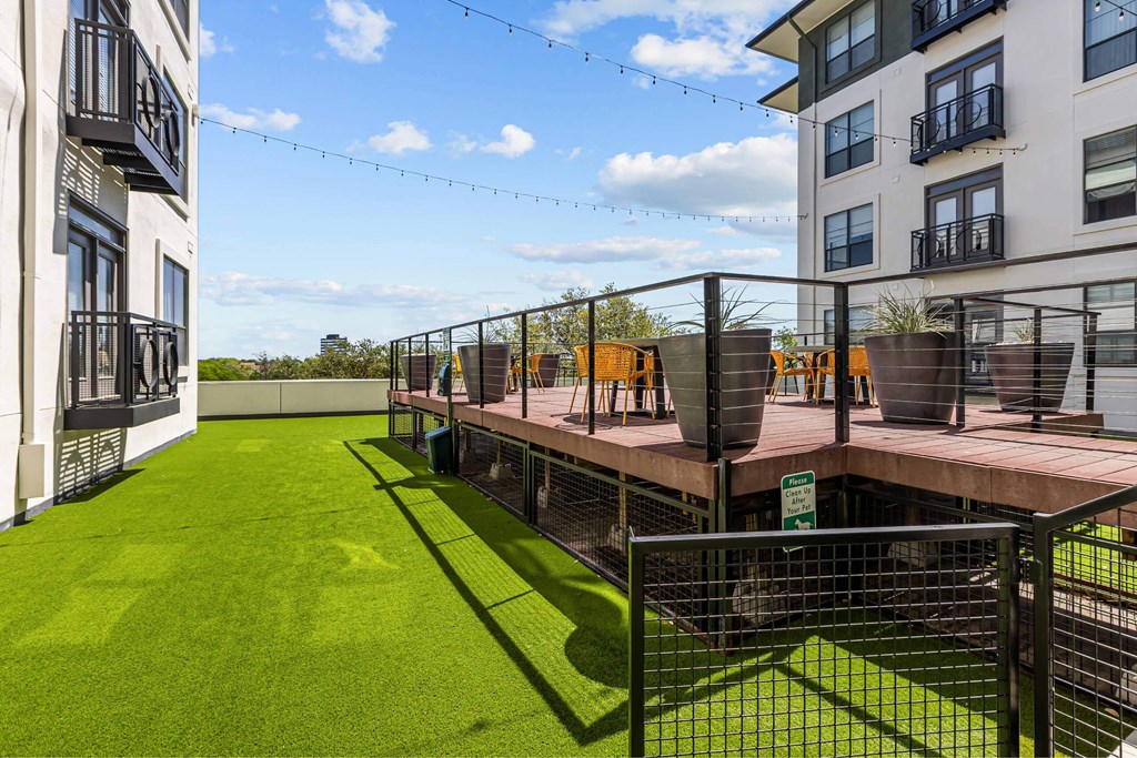 A rooftop garden with artificial grass and a tennis court.