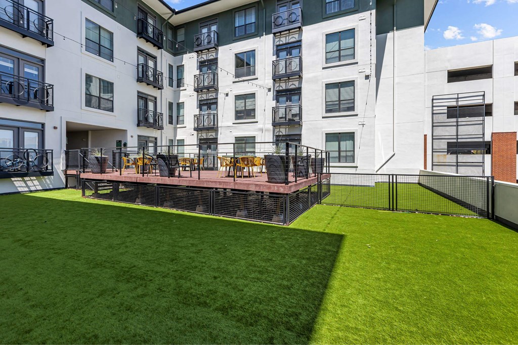 A large white building with a green lawn in front.