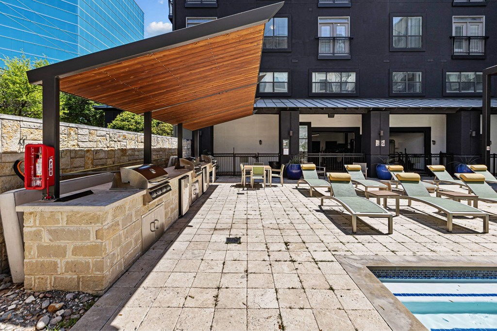 A pool area with sun loungers and a red post box.