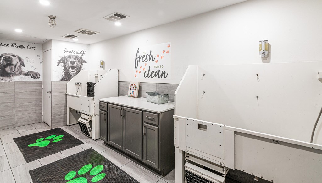 A dog grooming area with a sign that says fresh clean.