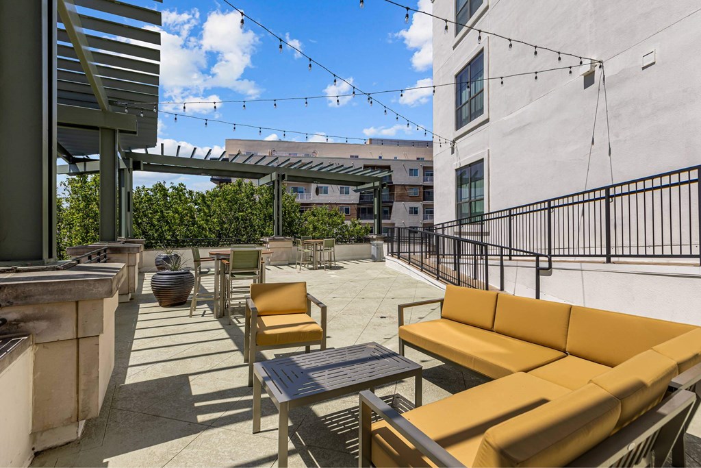 A patio with a table, chairs, and a bench.