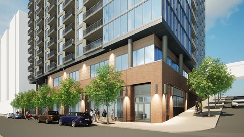 A modern building with a parking lot in front.