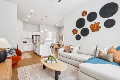 A living room with a white couch and a coffee table.