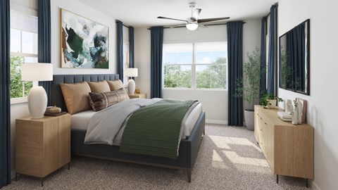 A bedroom with a large bed and a ceiling fan.