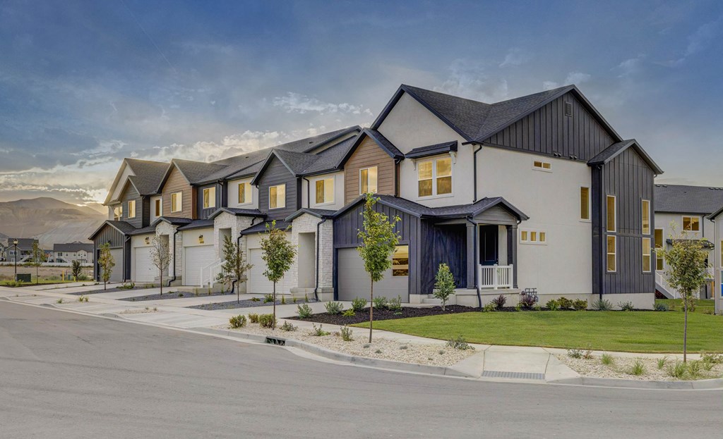 A row of modern houses with grey and yellow accents.
