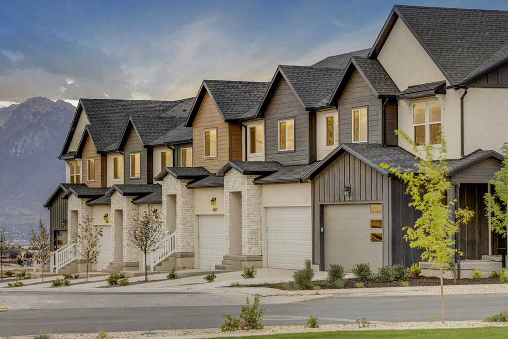A row of houses with a mountain in the background.