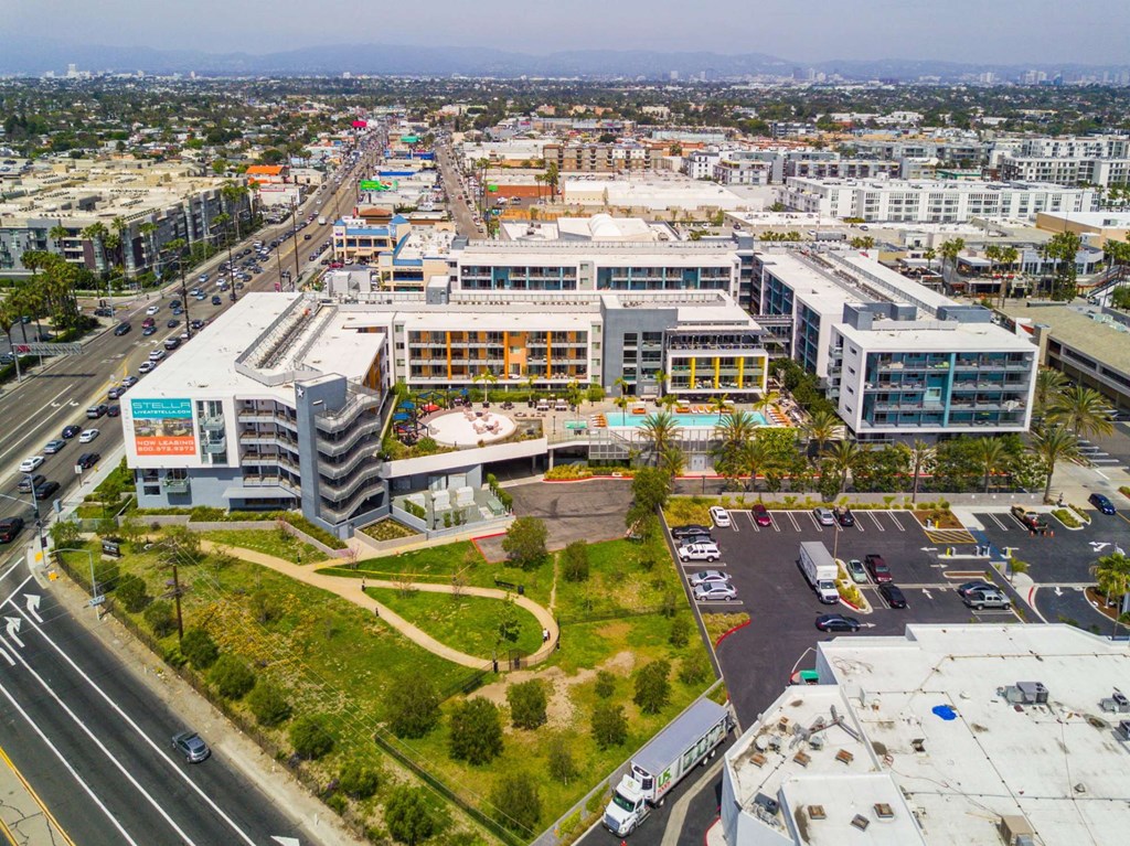 A large, modern building complex sits in the middle of a busy intersection.