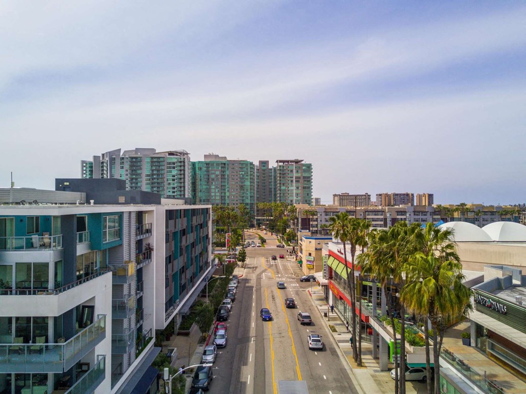 A street view of a city with cars and buildings.