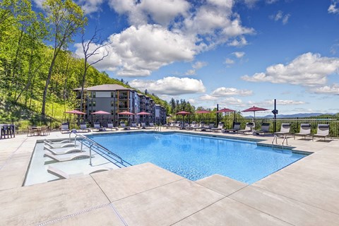 A large outdoor swimming pool with a mountain in the background.