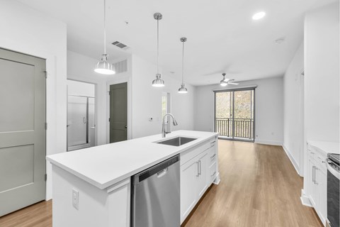 A modern kitchen with white cabinets and a large island.