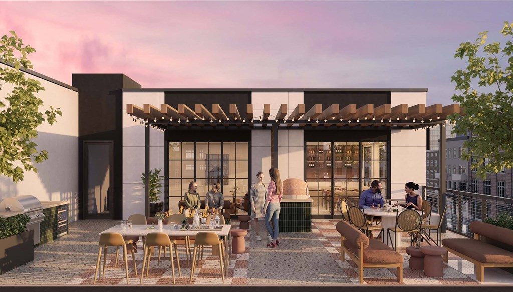 A group of people are sitting around a table on a patio.