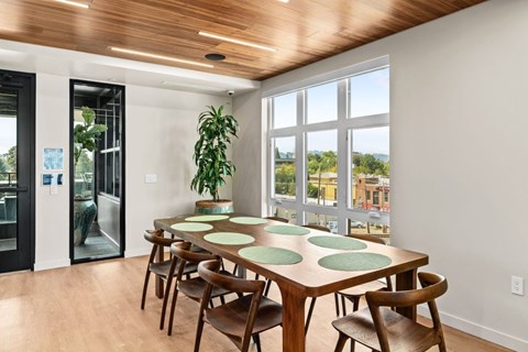 A dining room with a wooden table and chairs.
