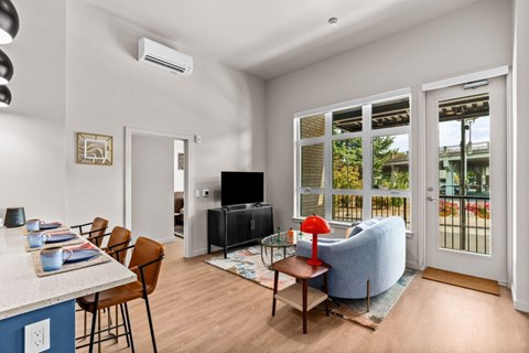 A living room with a blue couch and a television.