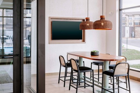 A modern dining room with a wooden table and chairs.