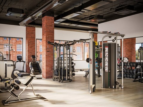 A gym with a variety of equipment including weights and a squat rack.