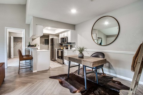 A modern kitchen with a dining table and chairs.