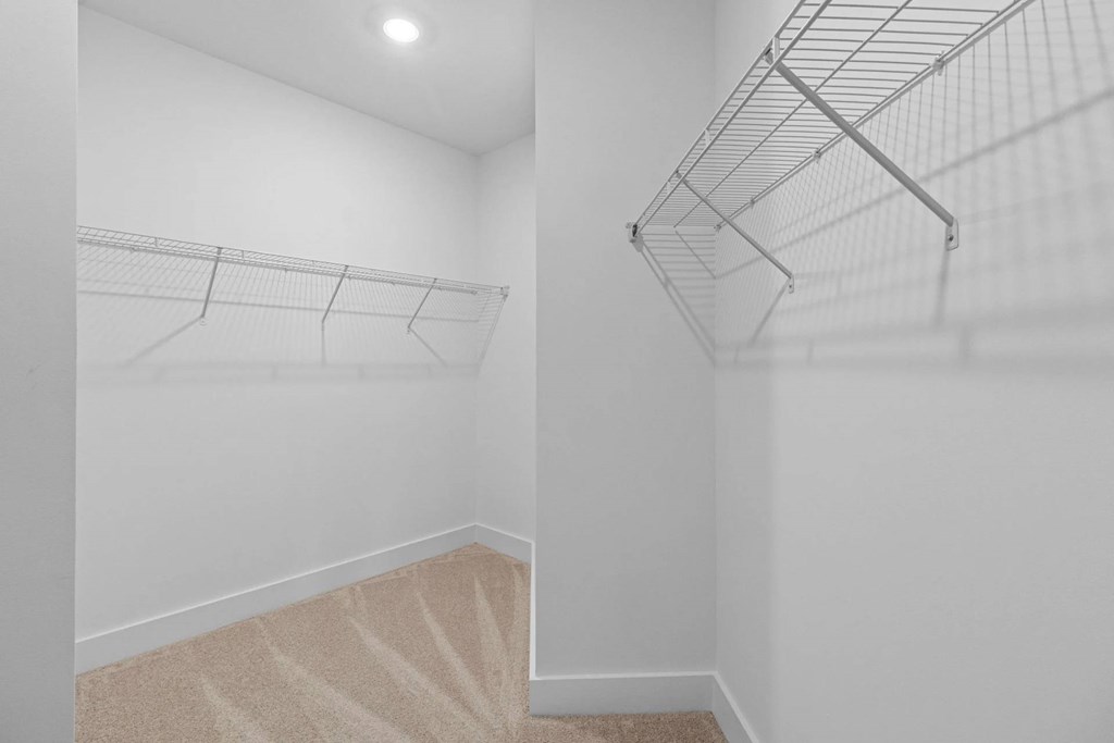 Empty room with a carpeted staircase.