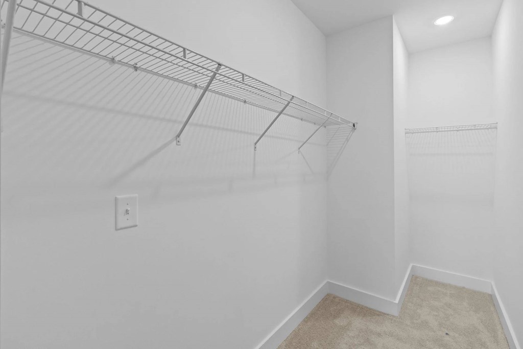 Empty room with a shelf and a light switch.