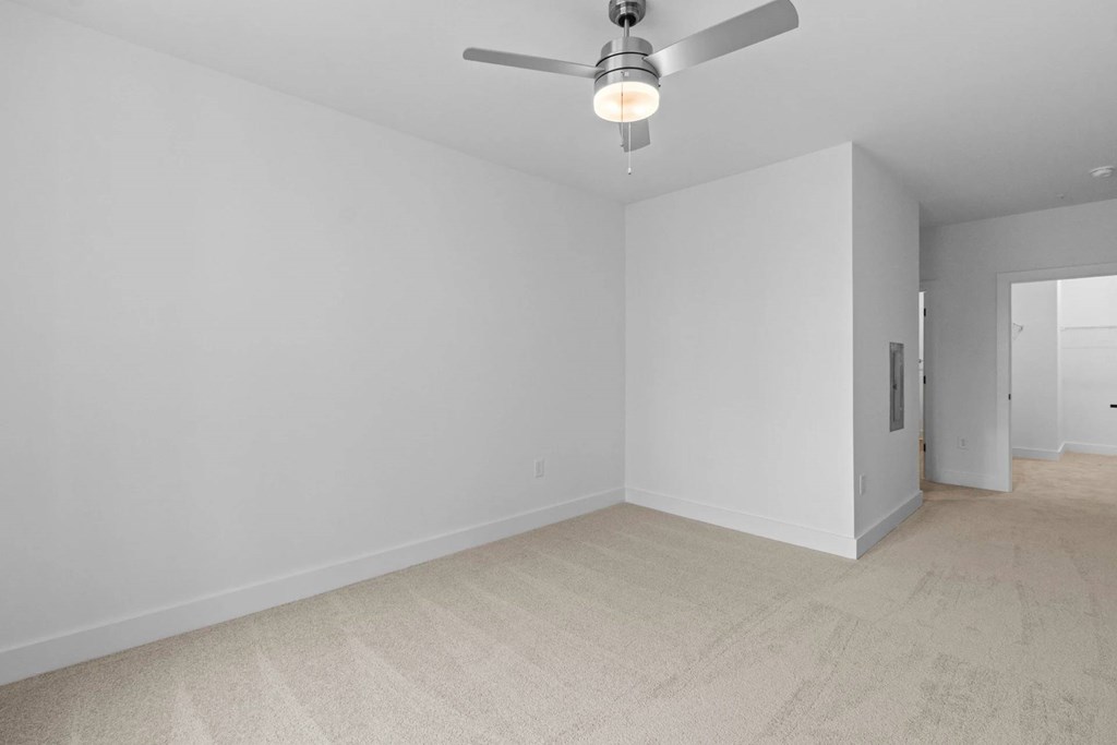 A room with a ceiling fan and a light bulb.