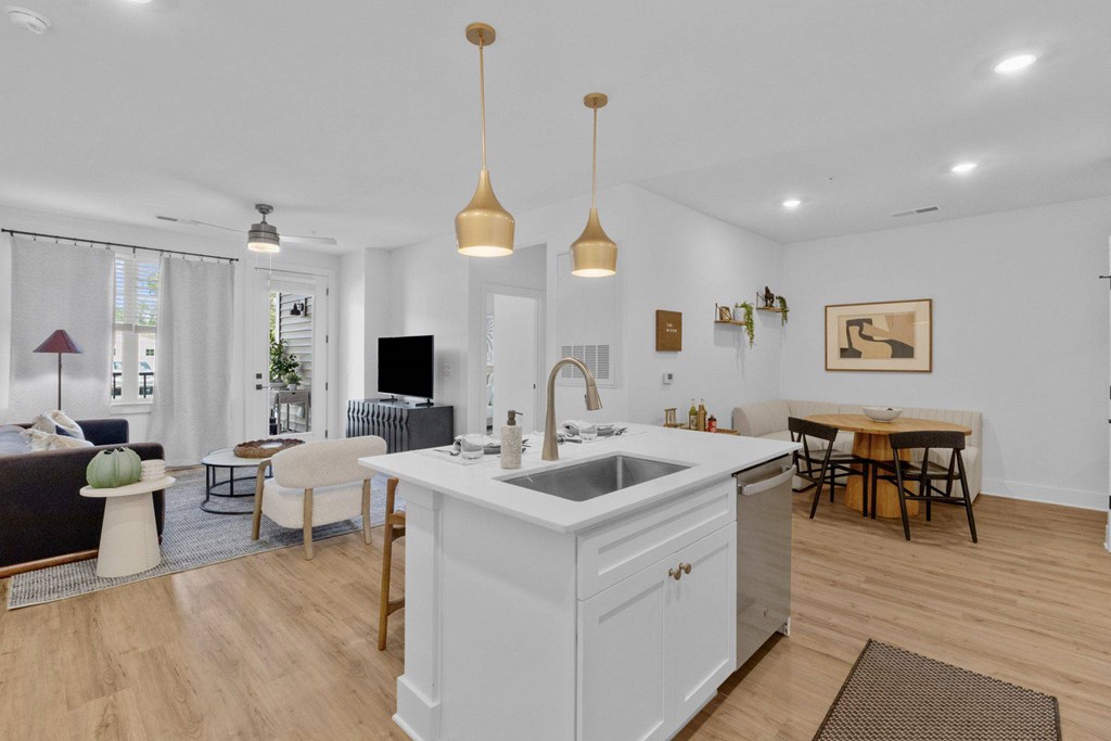 A kitchen with an island and wooden floors.