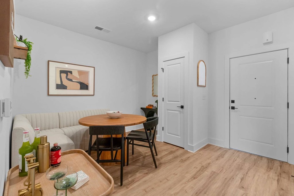 A dining area with a table and chairs