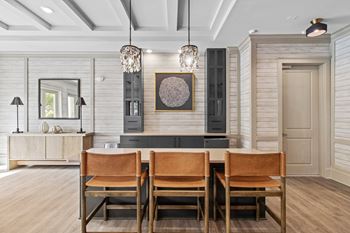A dining room with a wooden table and chairs.