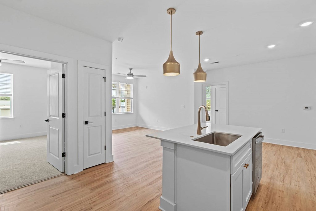A kitchen with a sink and a counter.
