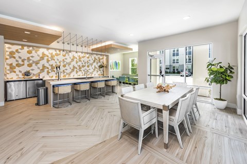 A dining room with a white table and chairs.