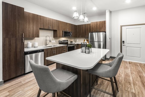 A modern kitchen with a dining table and chairs.