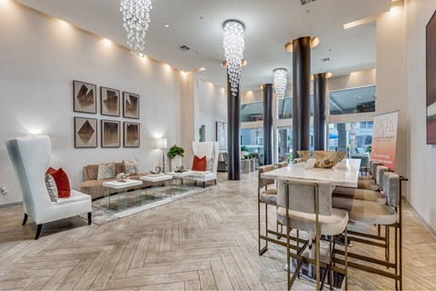 A modern dining room with a glass table and chairs.