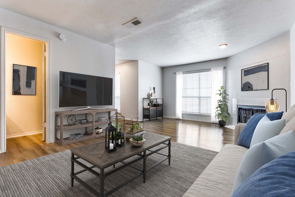 A living room with a grey sofa and a wooden coffee table.