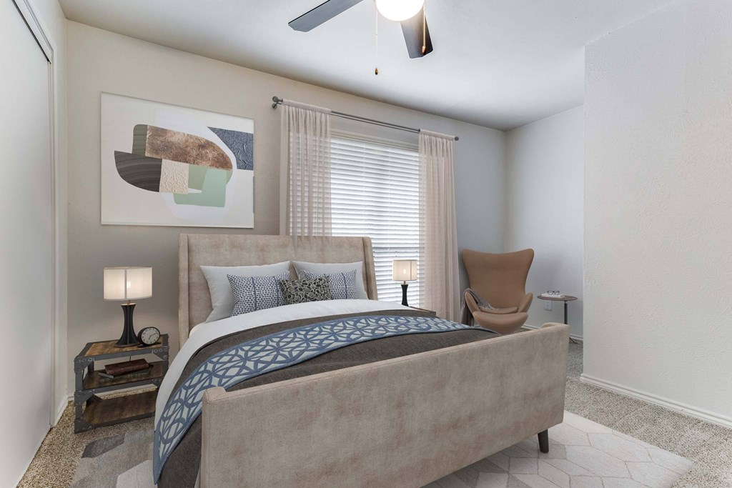 A bedroom with a large bed and a painting on the wall.