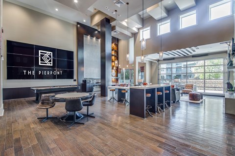 A modern office space with wooden floors and a bar area.