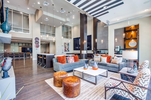 A modern living room with a grey couch and a wooden floor.