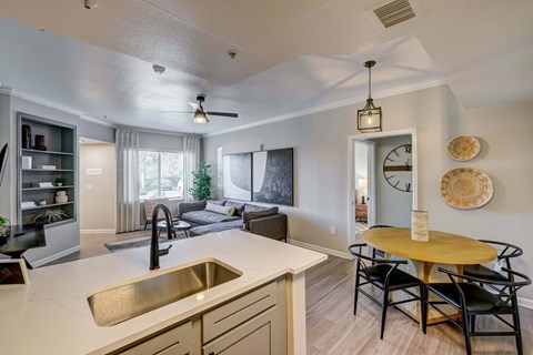 A modern kitchen with a dining table and chairs.