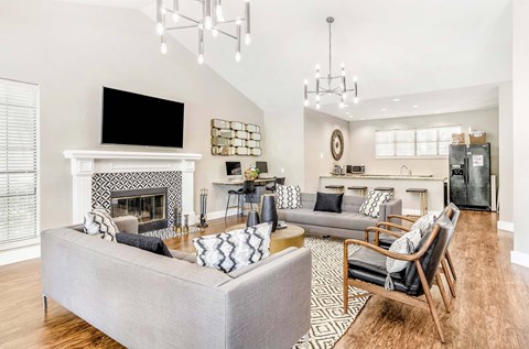 A modern living room with a grey sofa and a fireplace.