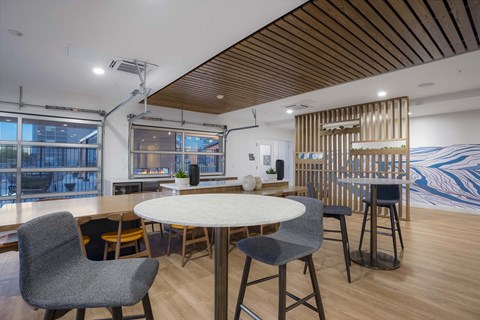 A modern dining area with a round table and chairs.