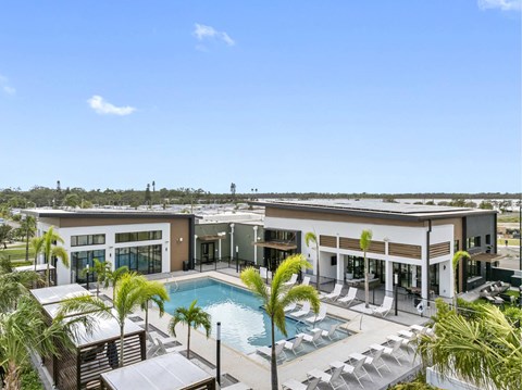 A large building with a pool in front of it.