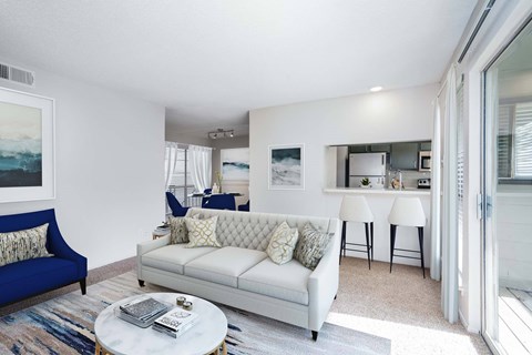 A living room with a blue couch and a white couch.