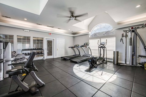 A spacious home gym with a variety of exercise equipment.