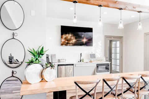 A modern dining room with a wooden table and chairs.